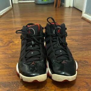 Black and red, size 8M, Jordan’s six rings.